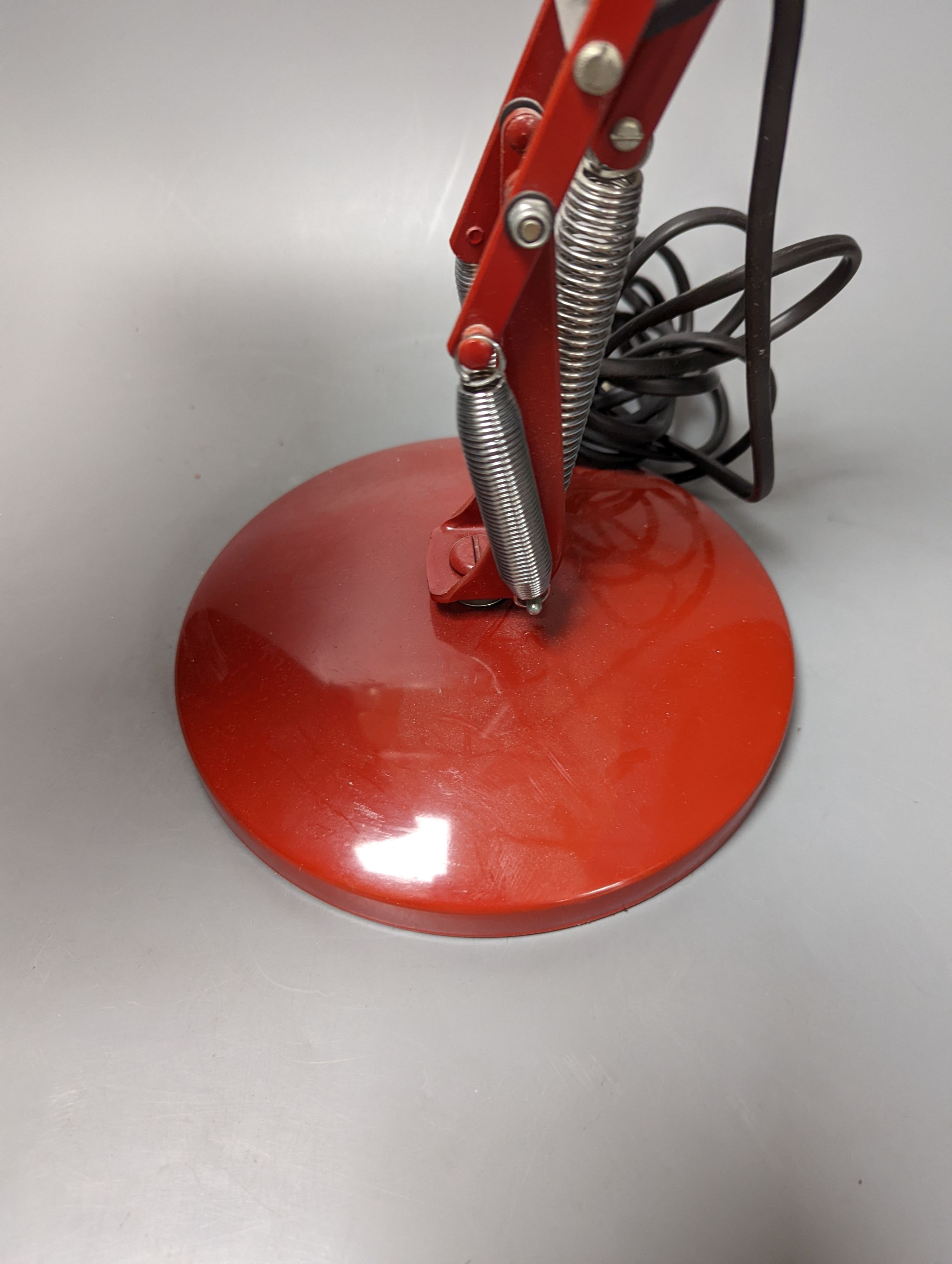 A red anglepoise table lamp, 79 cms high.